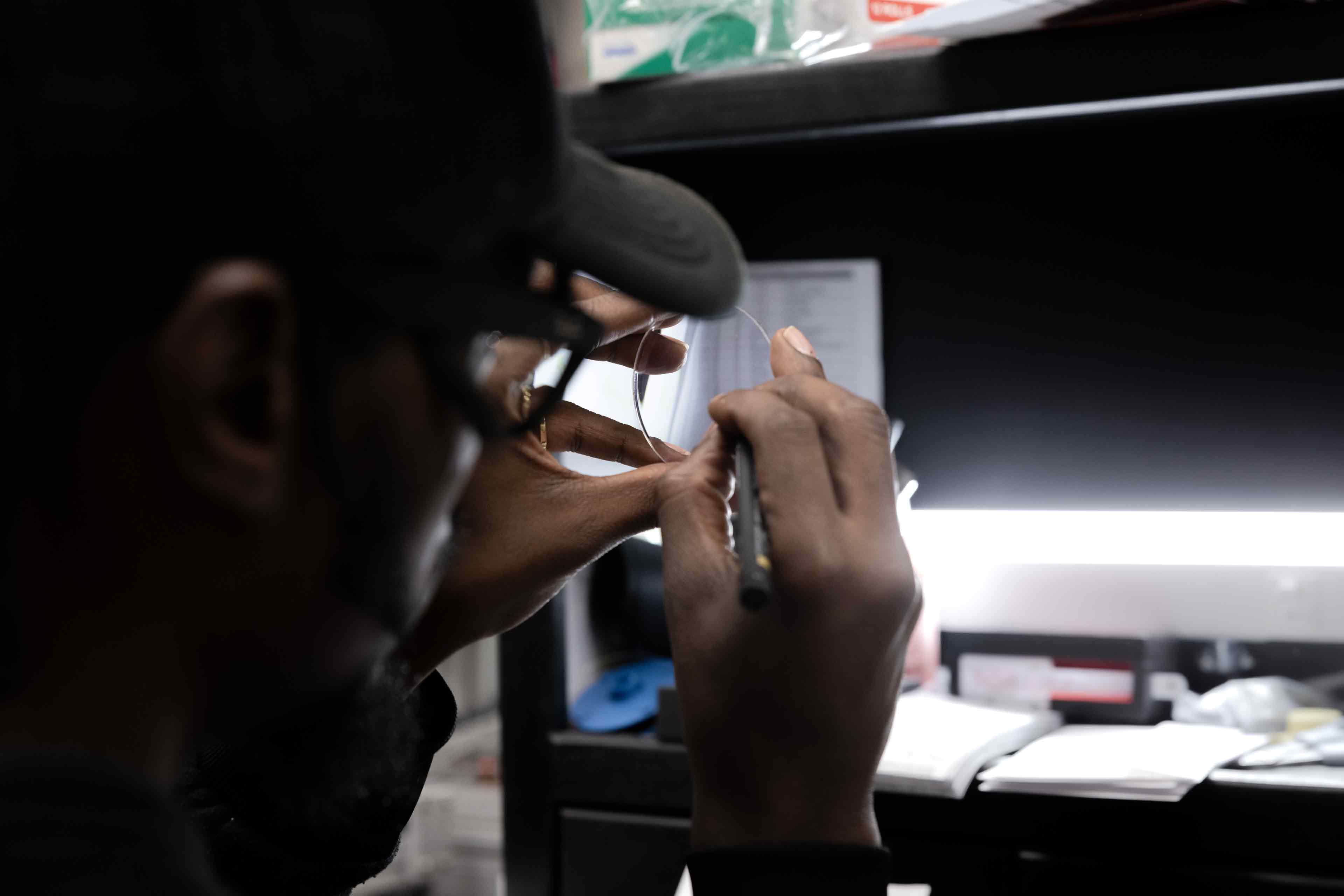 Person working on a eyeglass lens.