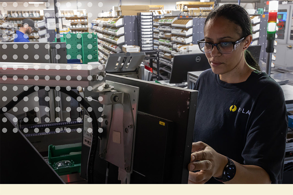 Person working in a Rlab setting with shelves and equipment in the background