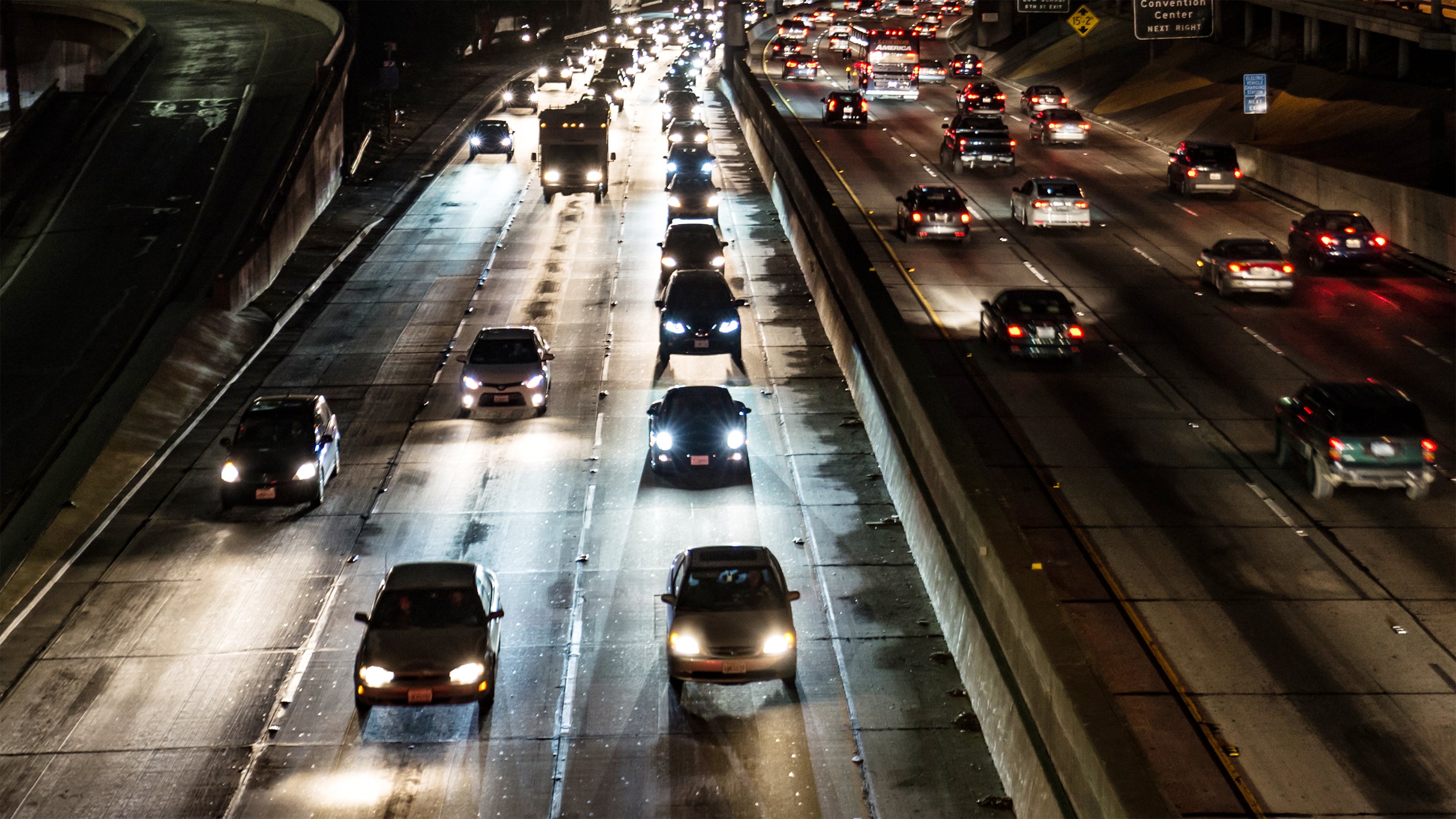 Heavy traffic on a highway at night with multiple lanes of traffic.