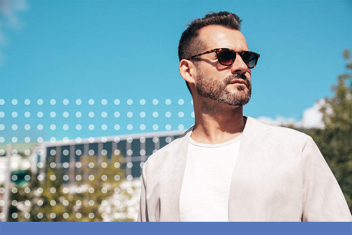 Man wearing sunglasses with a blurred outdoor background