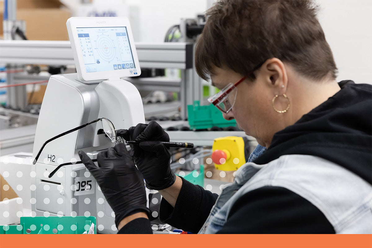 Employee of Rlab checking the lends on a pair of glasses.