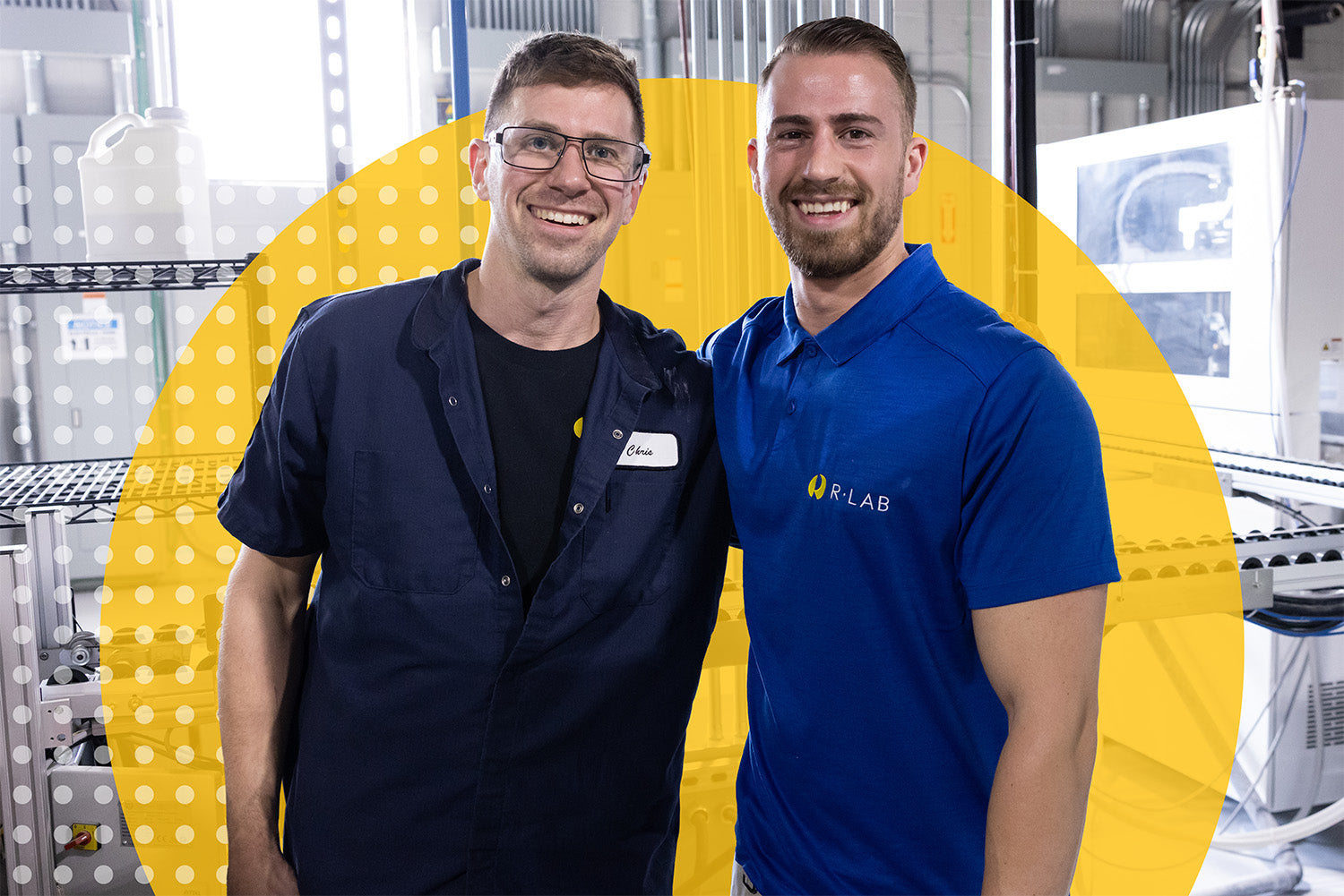 Two men standing together with a yellow circle background, one wearing a navy shirt and the other in a blue shirt with 'KLAB' branding.