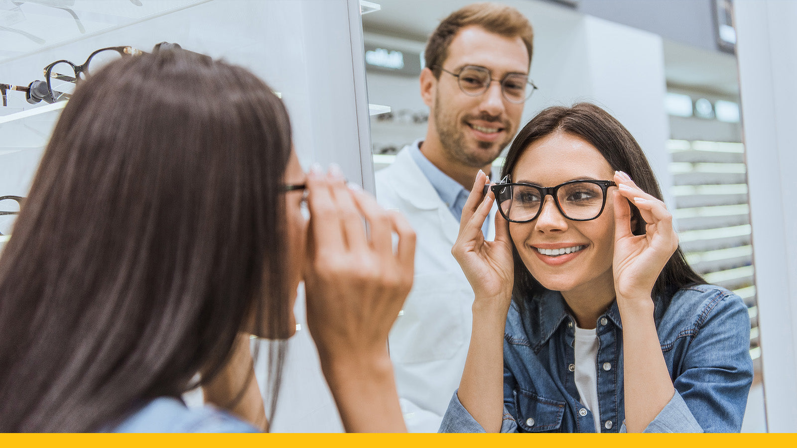 Woman trying on glasses with a optometrist in a clinic setting
