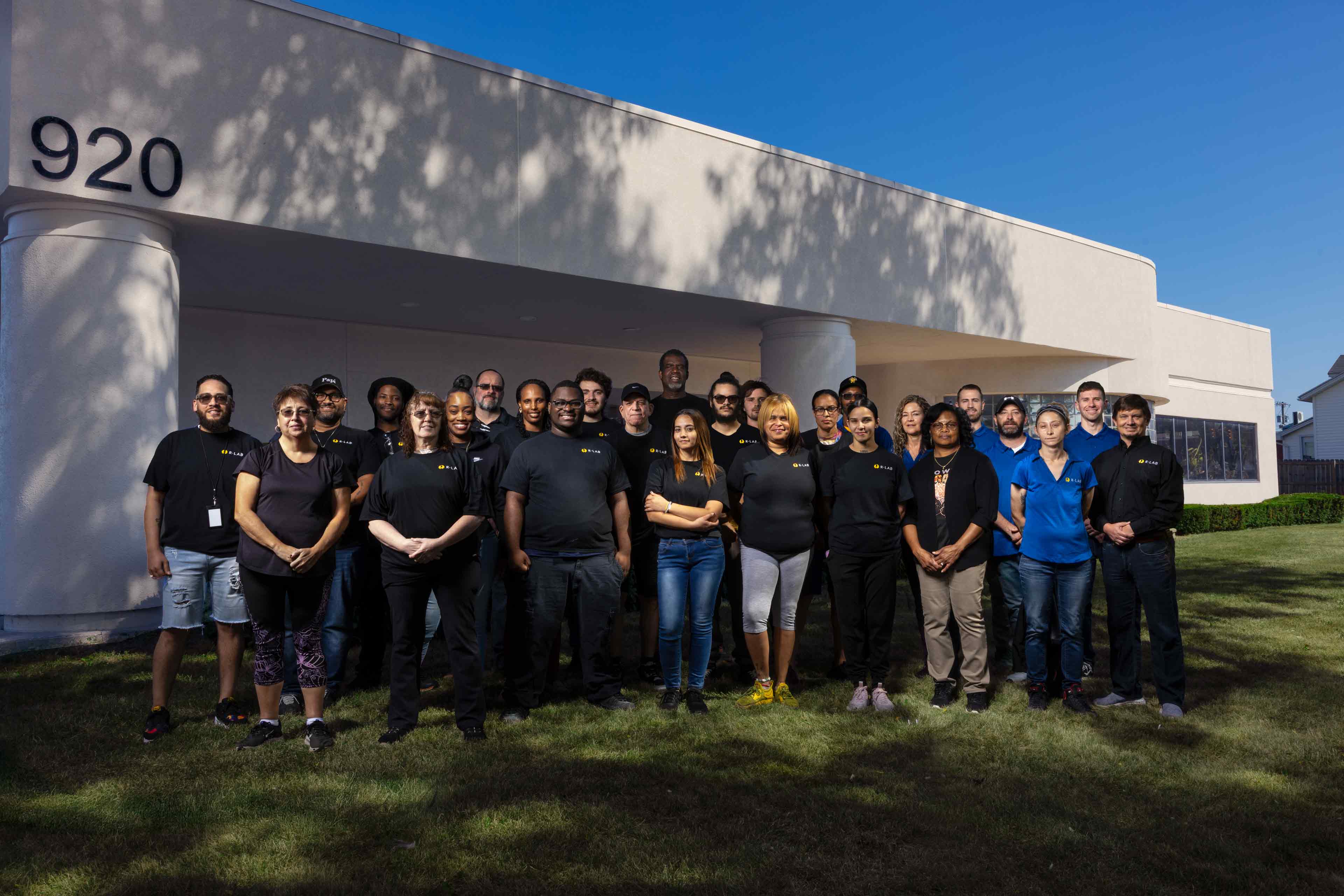 Team photo of Rlab employees outside the home office at 920 Emerson Rd, 